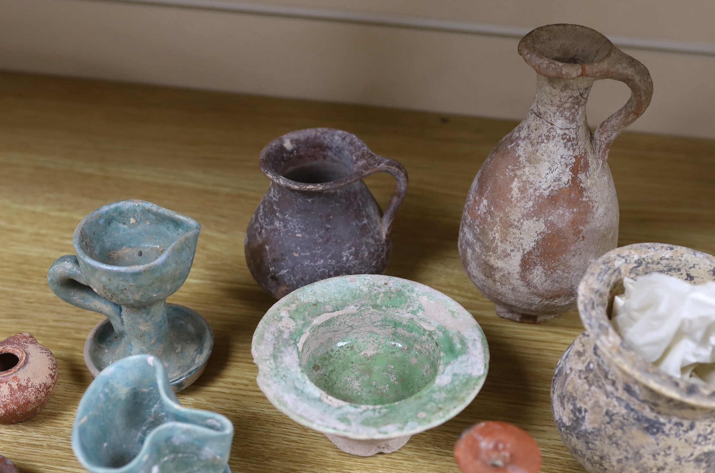 A group of pottery ‘antiquities’, to include Roman, early Christian, Byzantine and Syrian, the largest 17cm high (9), provenance: the owner collected these items in the 1970s, some with original receipts